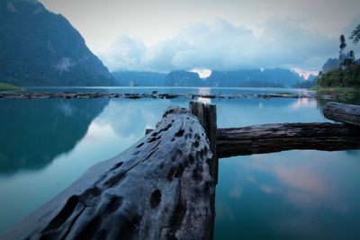 Scenic view of lake by mountains against sky