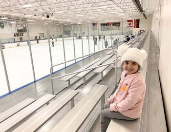 A young girl posting on an arena 