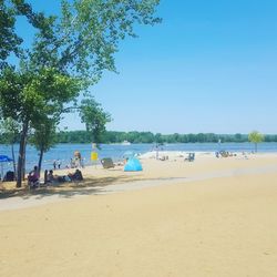 Scenic view of beach against clear blue sky