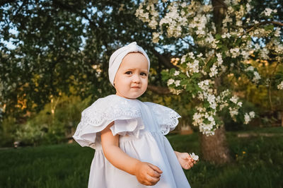Portrait of cute girl standing against plants