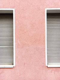 Windows on pink wall