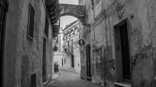 Narrow alley amidst old buildings in city