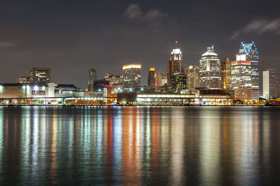 Illuminated city at waterfront at night