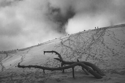 Scenic view of desert against cloudy sky