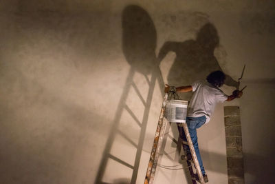 Shadow of man and woman walking on tiled floor