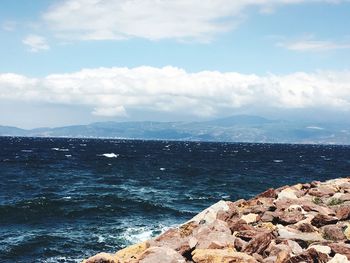 Scenic view of mountains against cloudy sky