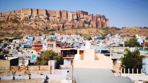 Buildings in city against clear sky