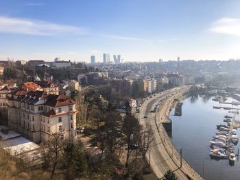 High angle view of city by river against sky