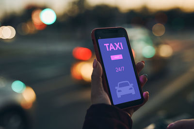 Woman ordering taxi online using mobile app on smart phone. booking taxi using application online