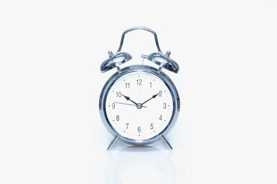 Close-up of clock against white background