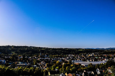High angle shot of townscape against blue sky