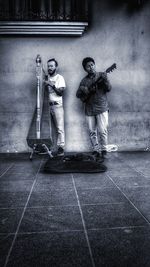 Statue of man standing on footpath