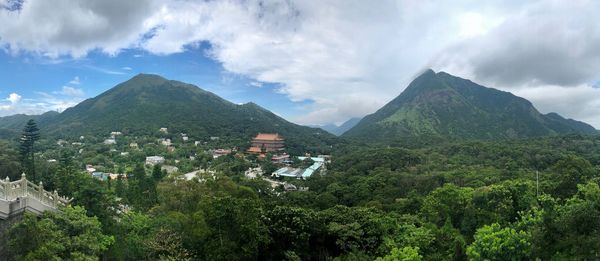 Panoramic view of townscape and mountains against sky