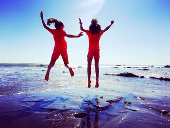 Woman jumping on beach