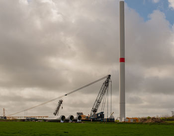 Low angle view of cranes against sky