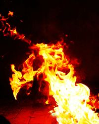 Close-up of fire burning at night