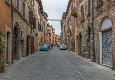 Street amidst buildings in city against sky