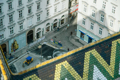 High angle view of people on street amidst buildings in city