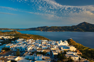 High angle view of townscape by sea against sky