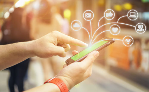 Close-up of woman holding mobile phone