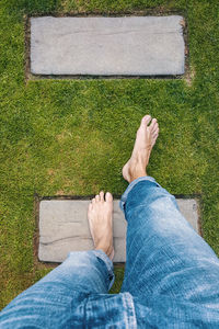 Low section of man relaxing on grass