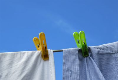 Close-up of textiles with clothespins on clothesline