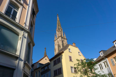 Low angle view of bell tower against blue sky