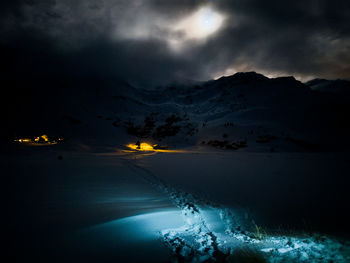 Scenic view of snow against sky during moonshine over mountains