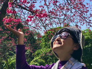 Woman appreciating plum blossom