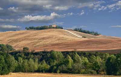 Scenic view of farm against sky