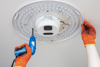 Cropped hand of man holding clock