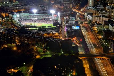 Aerial view of illuminated stadium in city at night