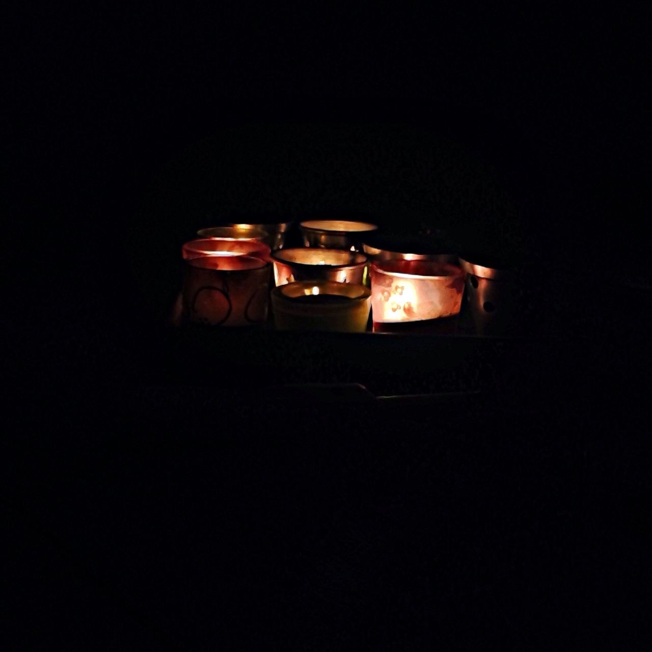 studio shot, copy space, black background, indoors, illuminated, red, dark, still life, close-up, night, single object, no people, darkroom, flame, cut out, table, candle, glowing, lit, old-fashioned