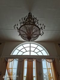 Low angle view of illuminated chandelier in building