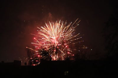 Low angle view of firework display at night