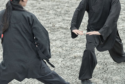 People practicing martial arts on land