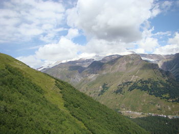 Scenic view of mountains against cloudy sky
