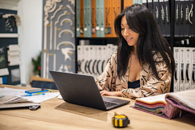 Businesswoman working on laptop at office