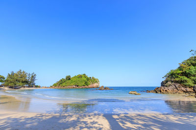 Scenic view of sea against clear blue sky