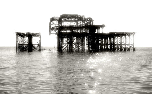 Pier on sea against clear sky