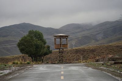 Empty road against mountains