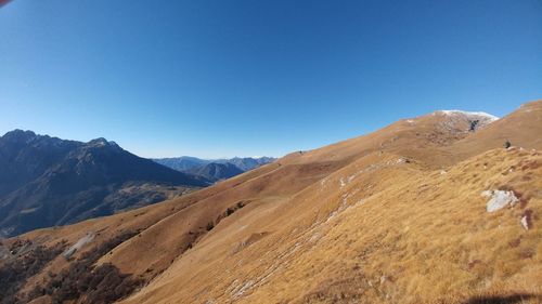 Scenic view of mountains against clear blue sky