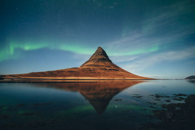 Scenic view of lake against sky at night