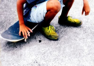 Low section of man skateboarding on floor