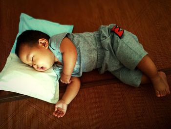 High angle view of baby sleeping on bed