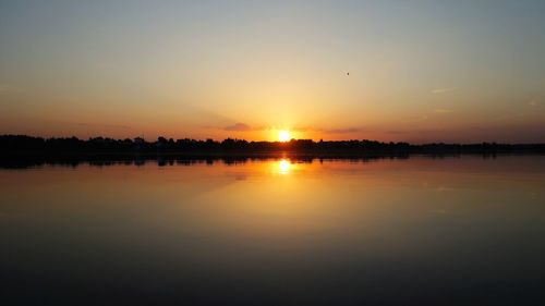 Scenic view of calm lake at sunset