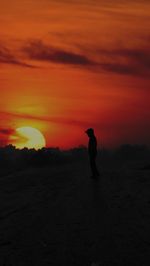 View if a man standing against sky during sunset