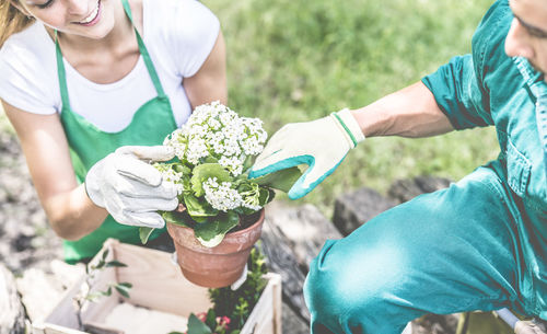 Friends with flower pot in yard