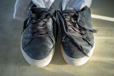 Low section of man wearing shoes