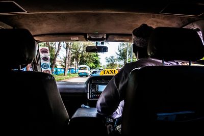 Rear view of man sitting in car